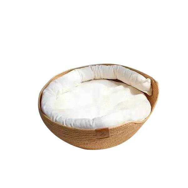 Woven pet bed with a white cushion on a white background

